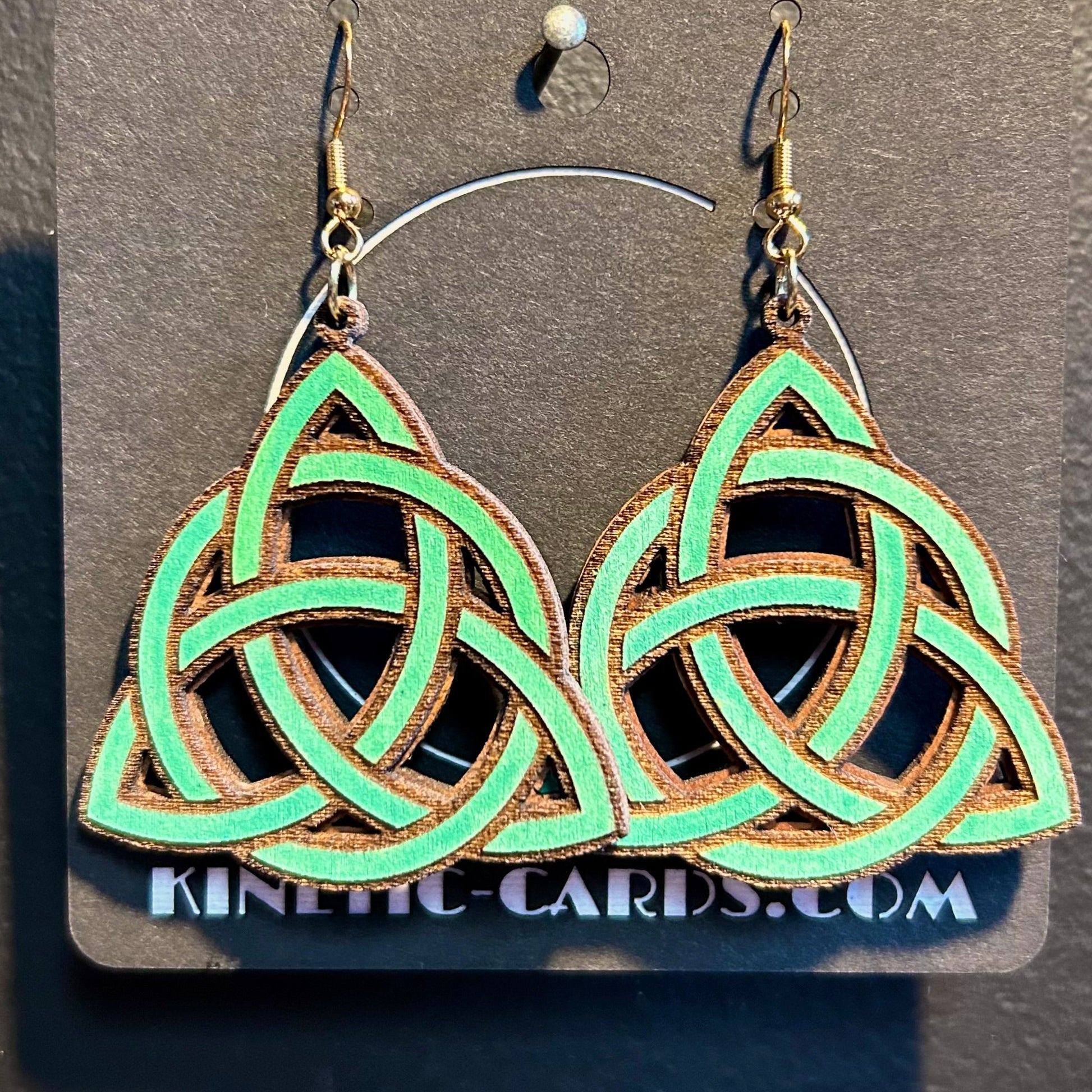 Celtic knot earrings on a Kinetic Cards display card against a gray background